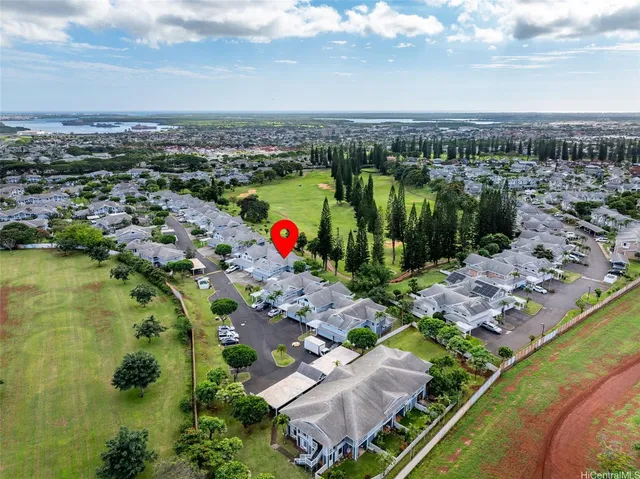 an aerial view of residential houses with outdoor space and swimming pool