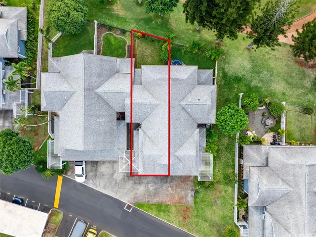 an aerial view of a house with a yard