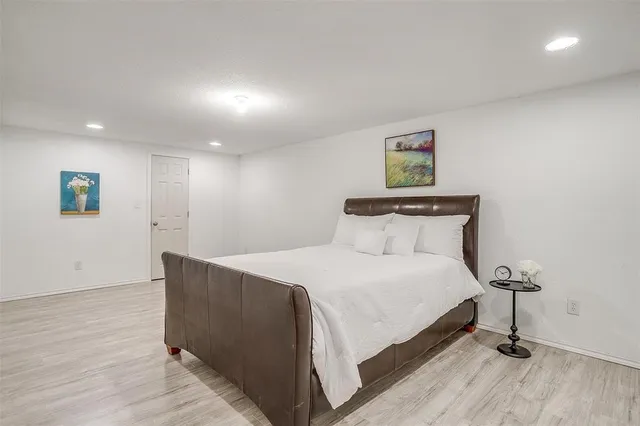 a bed room with a bed and a night stand