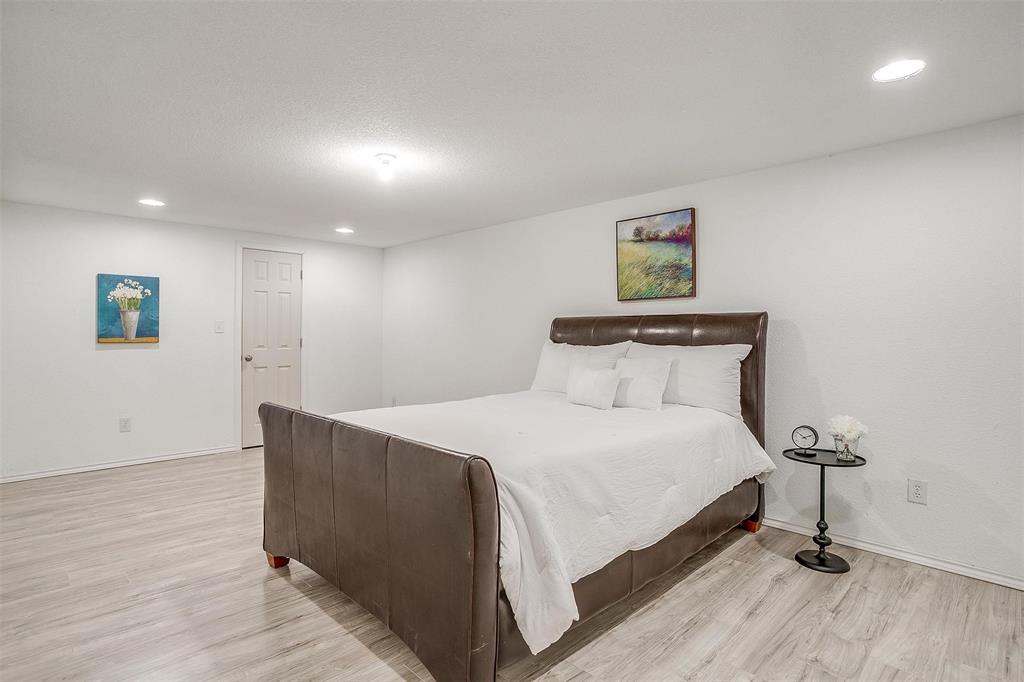 901 Remington Road Santo, TX 76472 - Photo 15 of 40 a bed room with a bed and a night stand