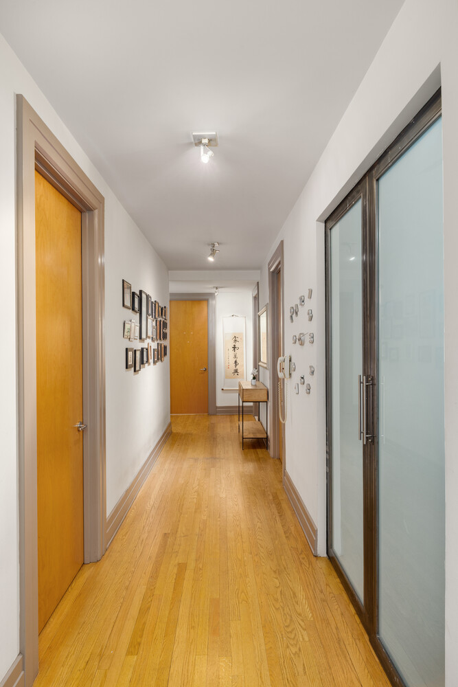 30 Main Street, Unit 3F Brooklyn, NY 11201 - Photo 8 of 12 a view of a hallway with wooden floor and furniture