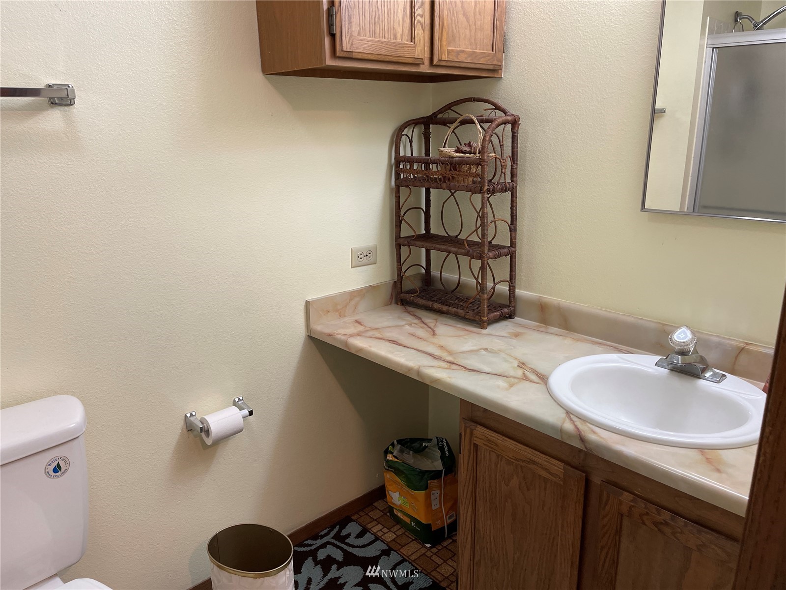 1803 East Tokio Road Ritzville, WA 99169 - Photo 13 of 35 a bathroom with a granite countertop sink a toilet and a mirror