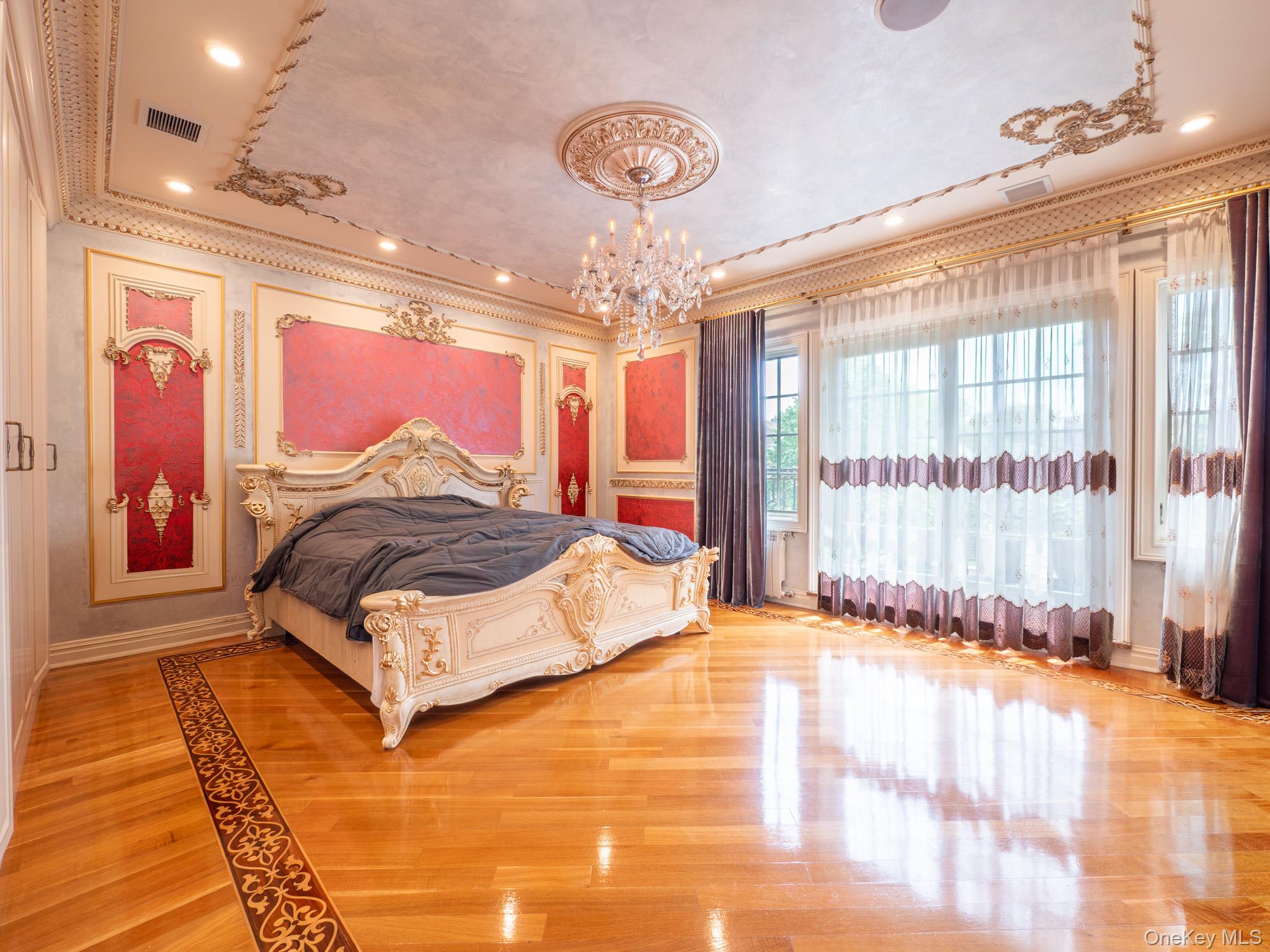 179-15 80th Road Queens, NY 11366 - Photo 13 of 35 a spacious bedroom with a large bed and a chandelier