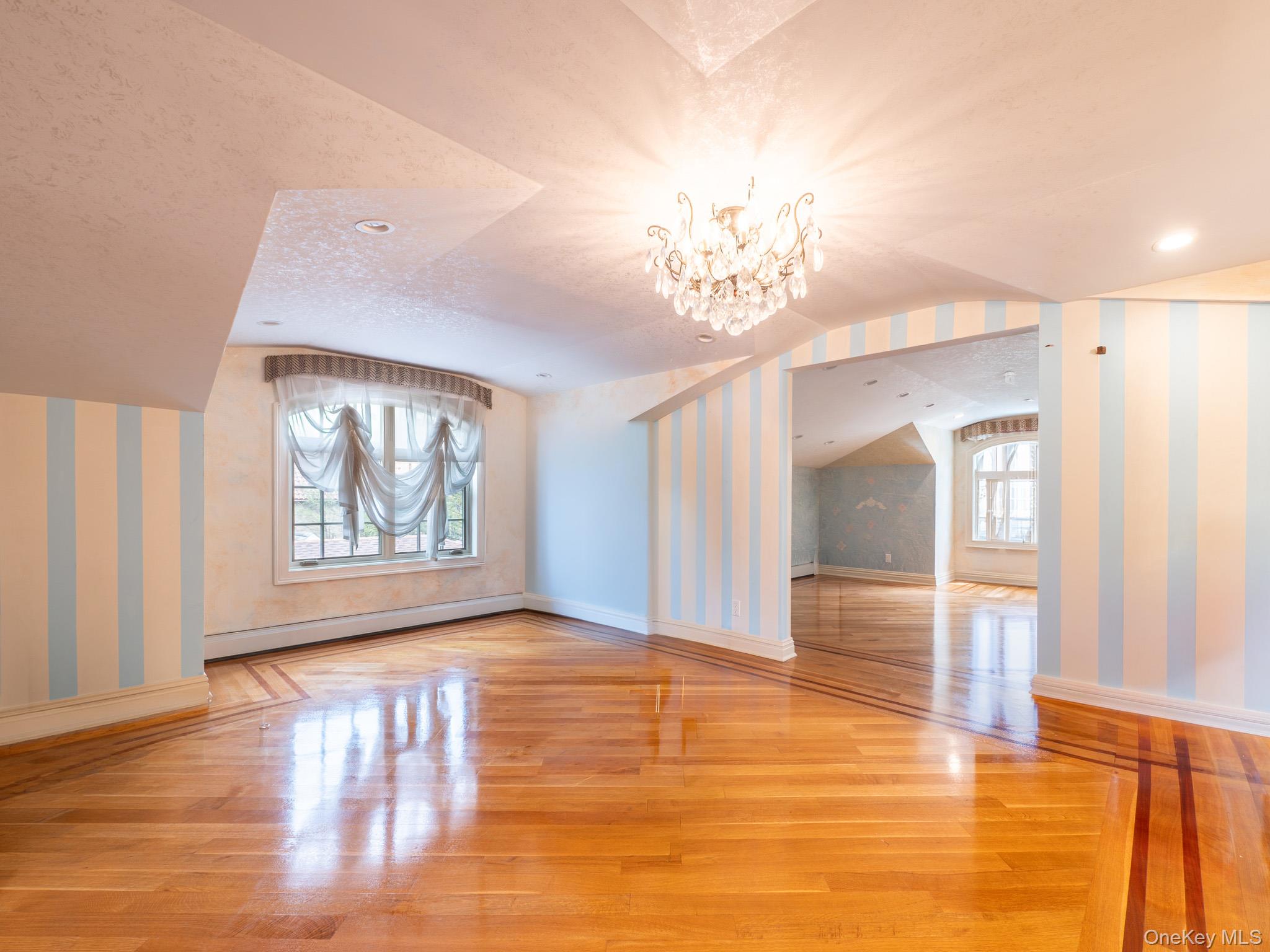 179-15 80th Road Queens, NY 11366 - Photo 21 of 35 a view of an empty room with window and wooden floor