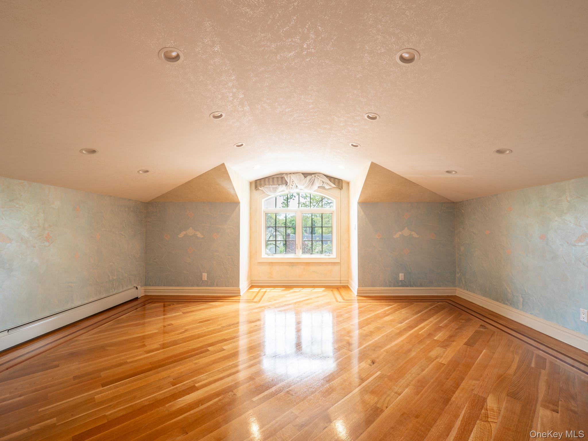 179-15 80th Road Queens, NY 11366 - Photo 22 of 35 an empty room with wooden floor and windows