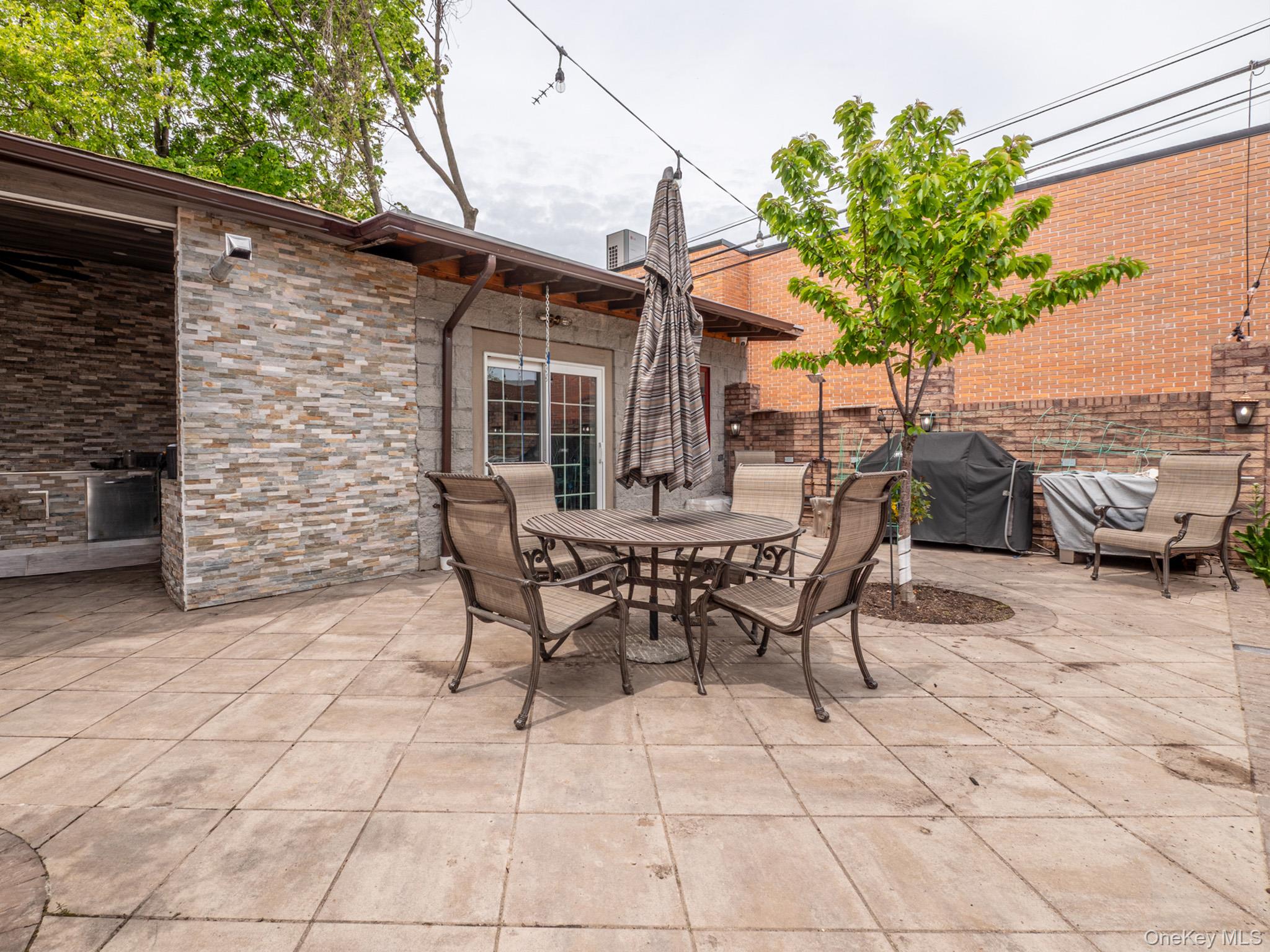 179-15 80th Road Queens, NY 11366 - Photo 31 of 35 a view of a patio with table and chairs and potted plants