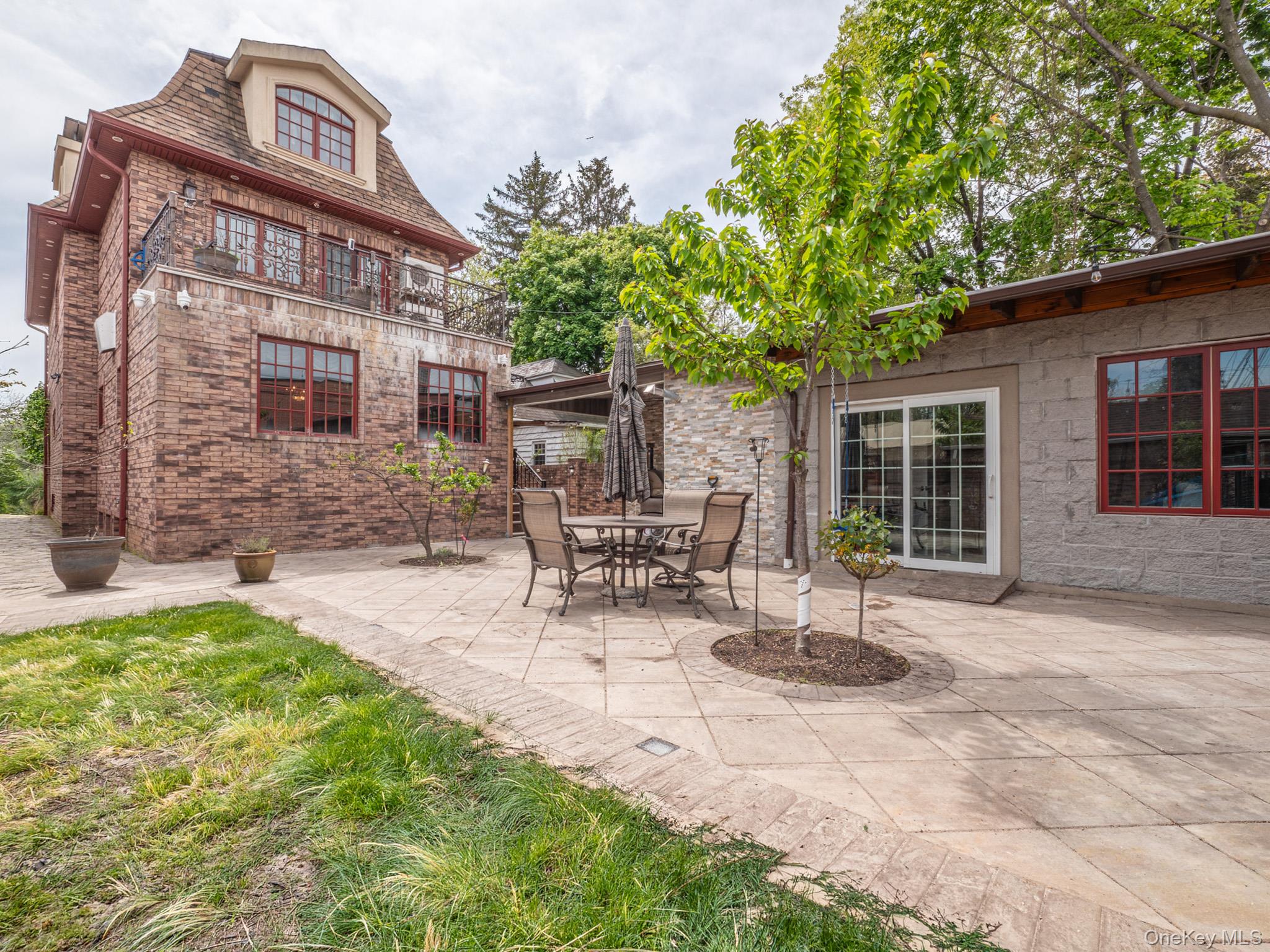 179-15 80th Road Queens, NY 11366 - Photo 32 of 35 a view of a brick house with a chairs in patio
