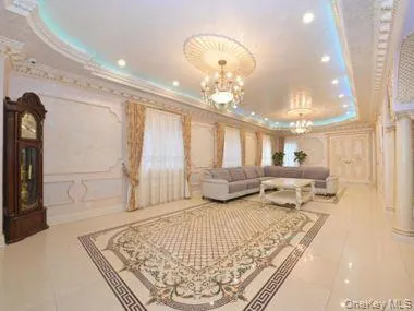 a living room with furniture and a chandelier