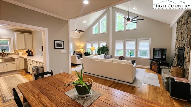 a large kitchen with a table chairs refrigerator and microwave