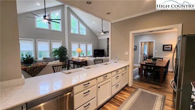 a bedroom with a bed a dresser and potted plants