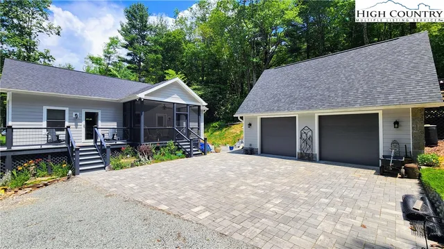 a front view of a house with garden and porch