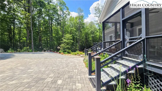 a view of a chairs and table in patio with a backyard