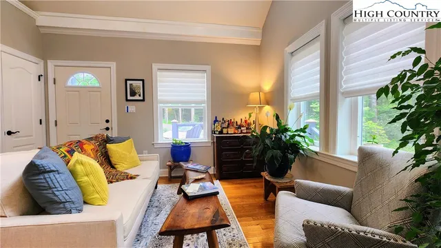 a living room with stainless steel appliances kitchen island furniture and a fireplace