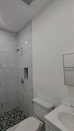an empty room with white walls and tiles