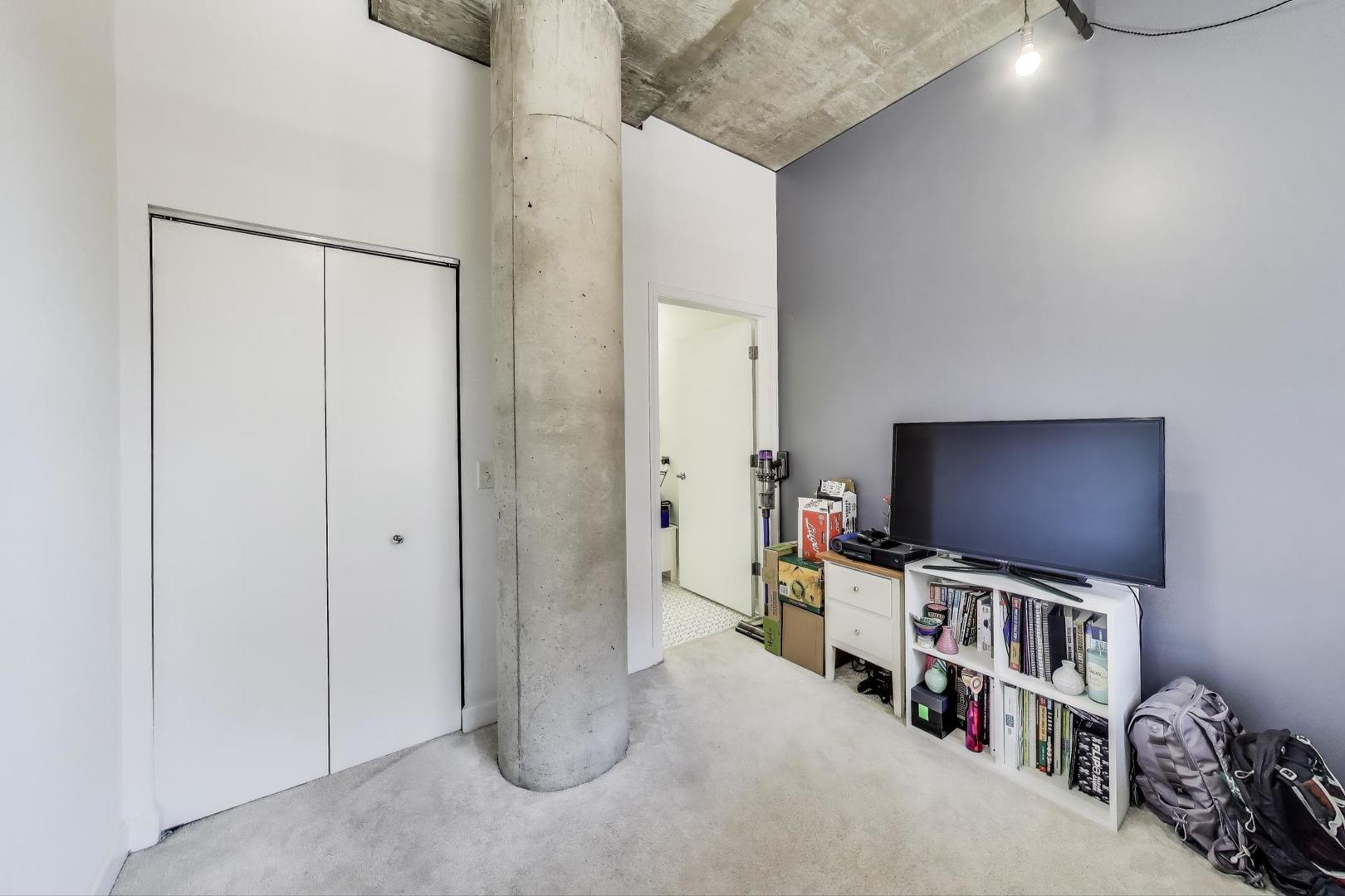 111 South Morgan Street, Unit 510 Chicago, IL 60607 - Photo 24 of 38 a room with furniture and a flat screen tv