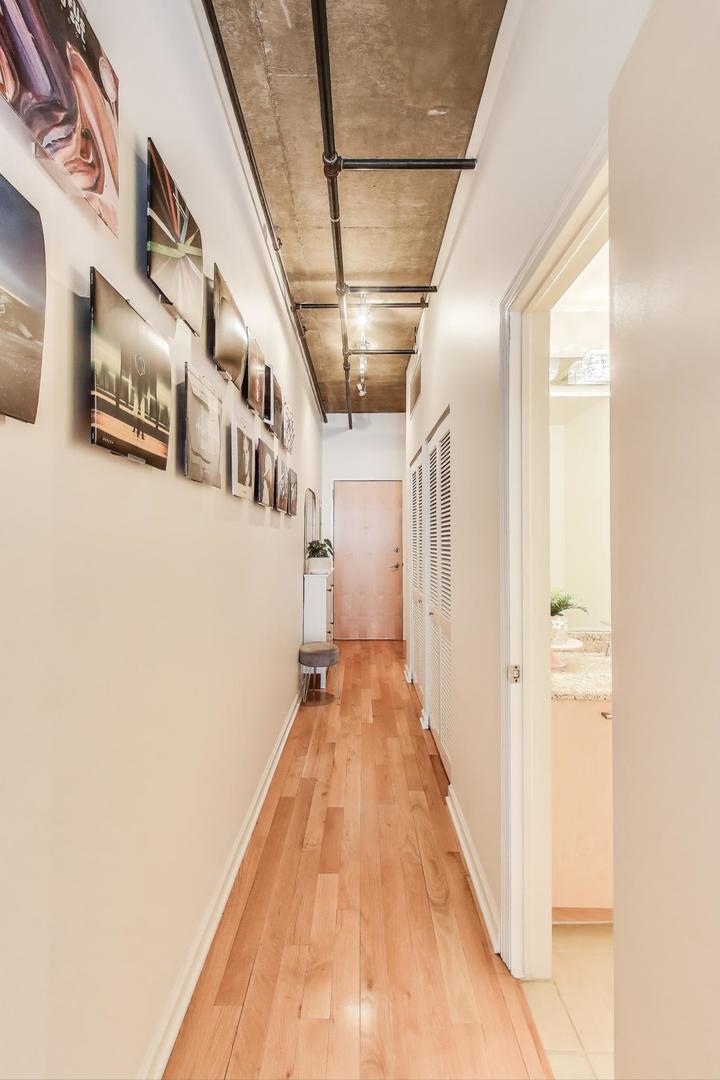 111 South Morgan Street, Unit 510 Chicago, IL 60607 - Photo 34 of 38 a view of a hallway with wooden floor