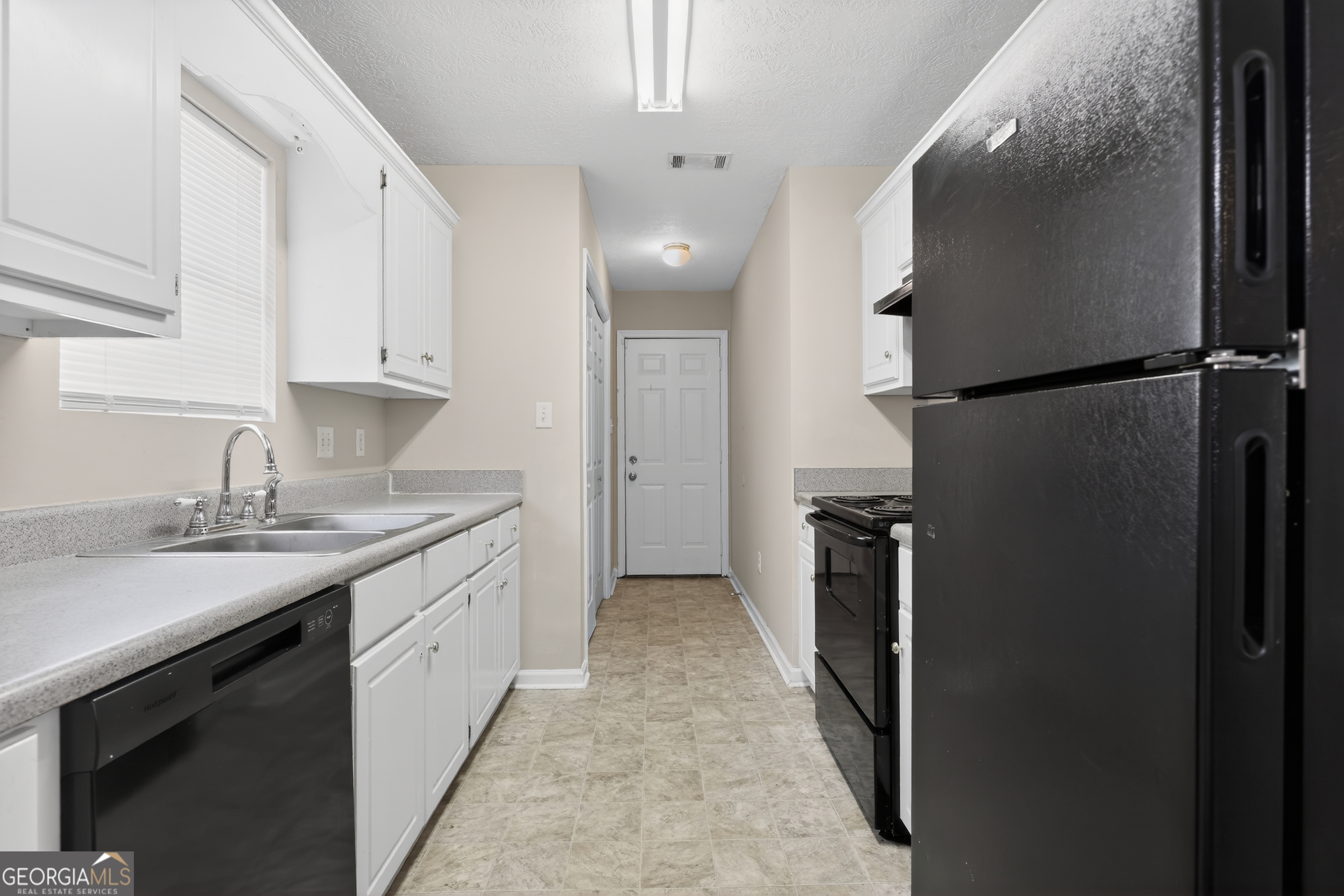 2902 Rasha Drive Augusta, GA 30906 - Photo 19 of 31 a kitchen with a sink and refrigerator