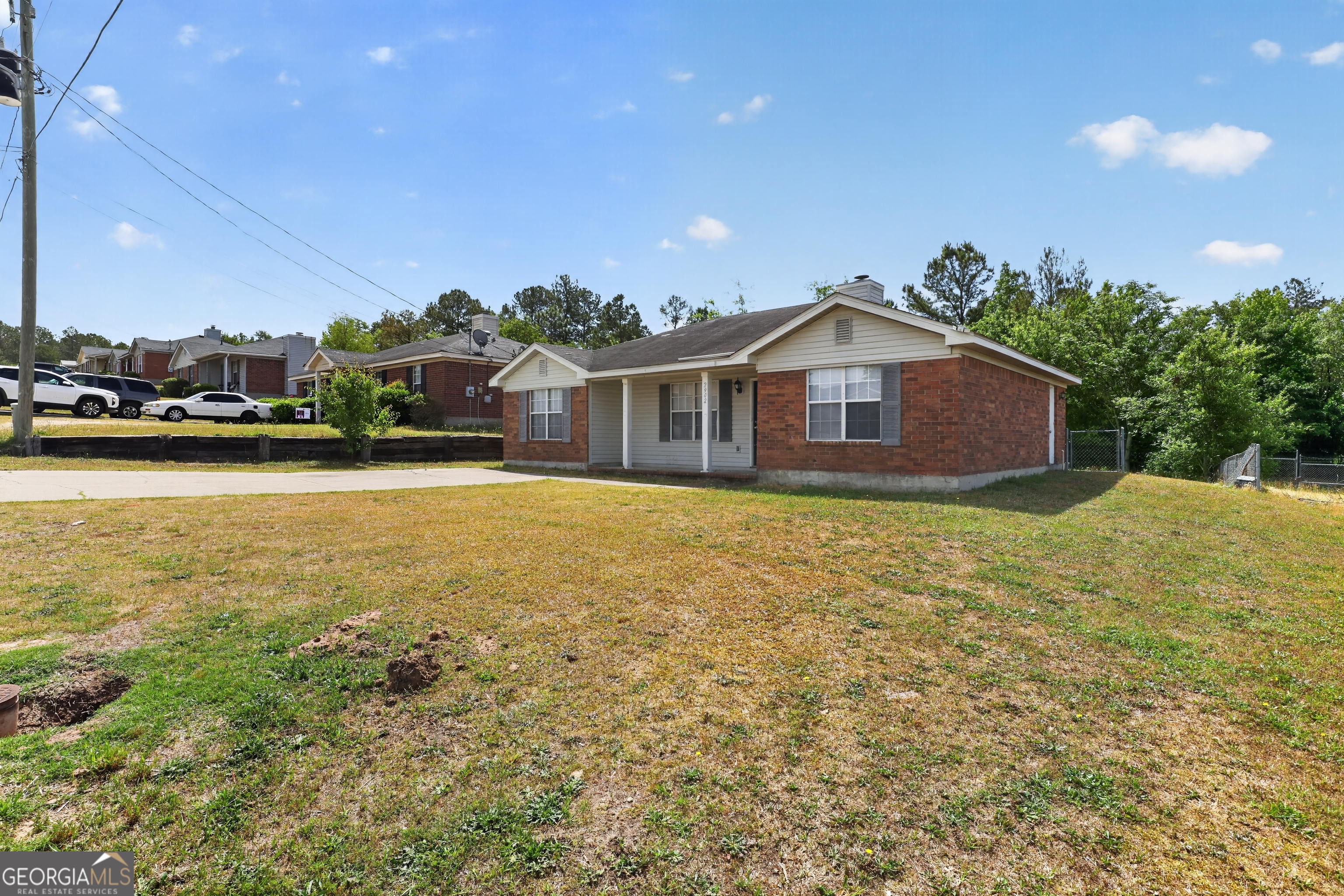 2902 Rasha Drive Augusta, GA 30906 - Photo 4 of 31 a front view of a house with a garden and lake view