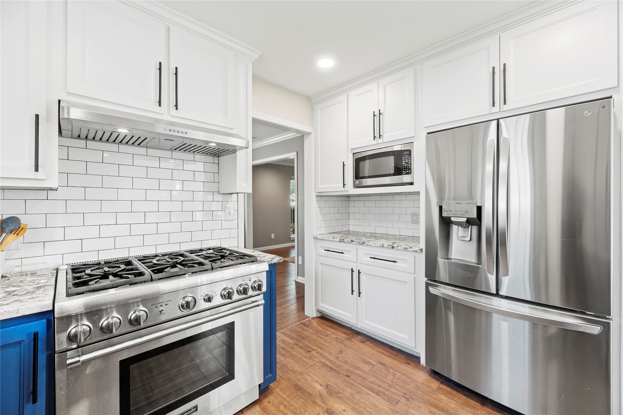 6031 McKnight Street Houston, TX 77035 - Photo 17 of 37 a kitchen with cabinets stainless steel appliances and wooden floor