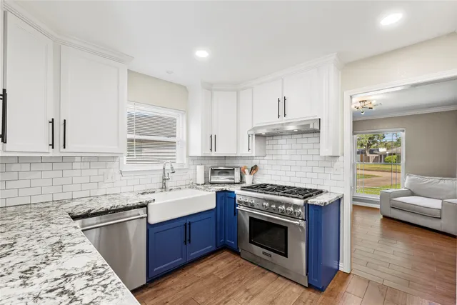 a kitchen with a sink stove and cabinets