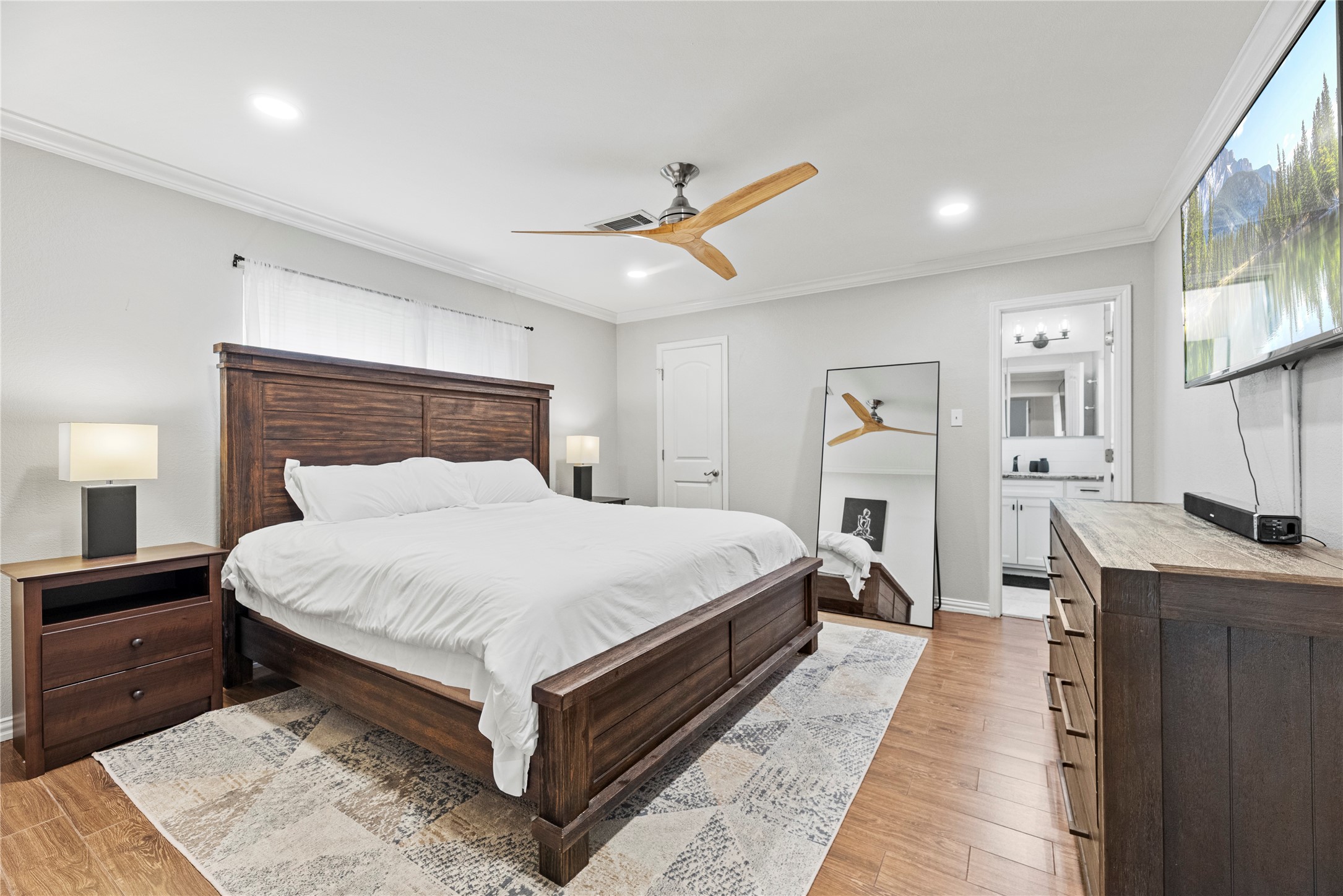 6031 McKnight Street Houston, TX 77035 - Photo 22 of 37 a bed room with a bed and a chandelier