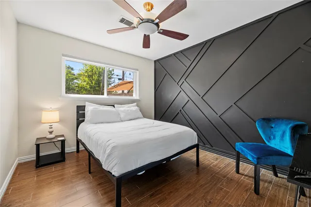 a bedroom with a bed and a couch