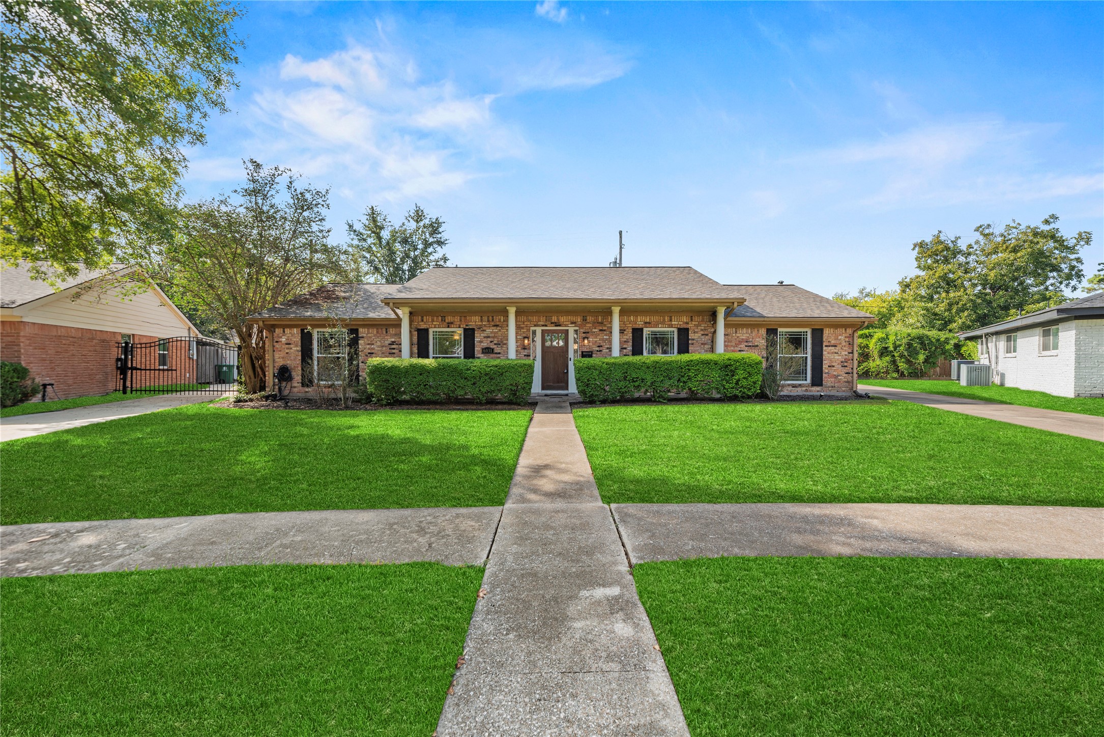 6031 McKnight Street Houston, TX 77035 - Photo 3 of 37 a front view of a house with a yard and potted plants