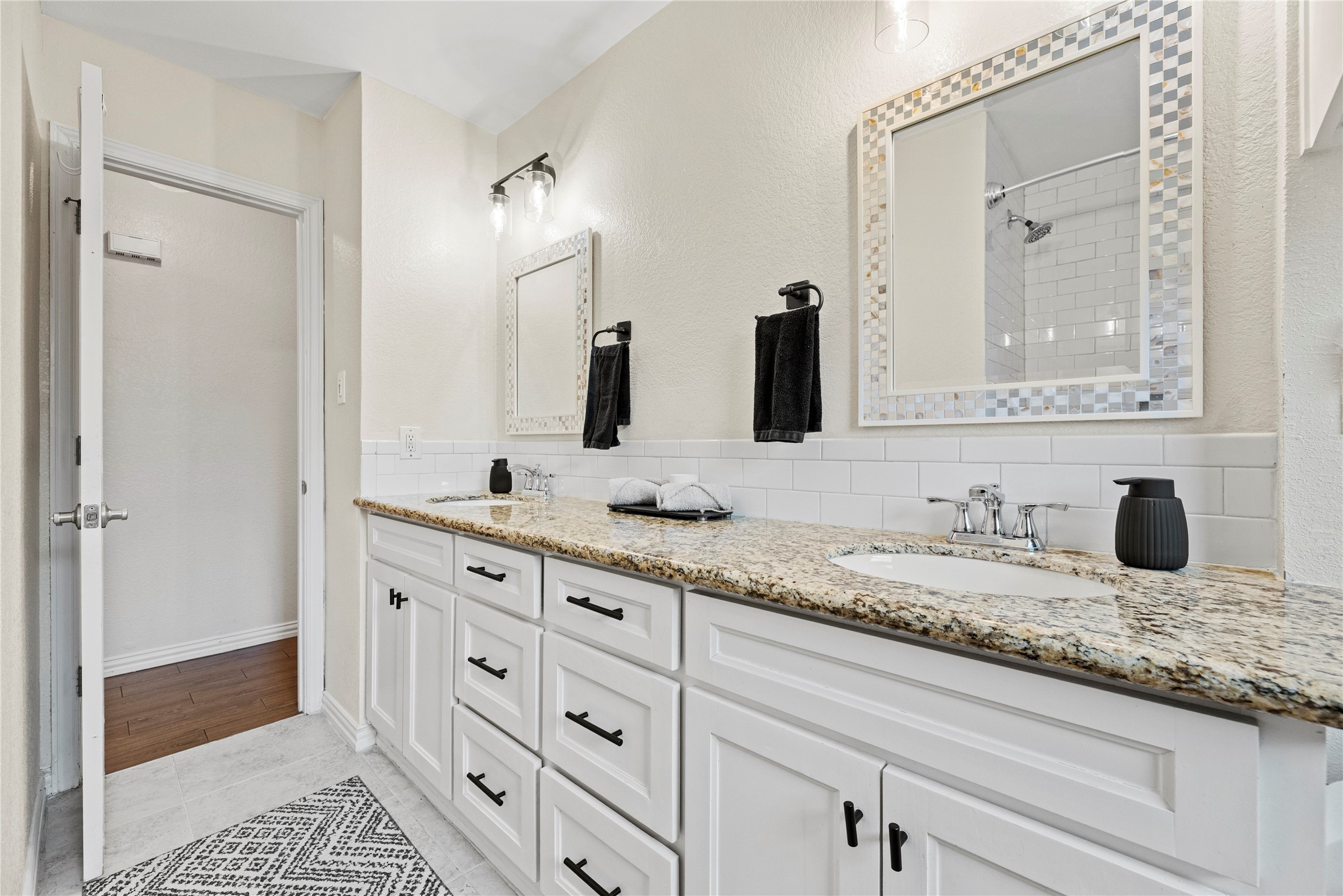 6031 McKnight Street Houston, TX 77035 - Photo 31 of 37 a bathroom with double sink and a mirror