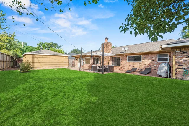an aerial view of a house with a yard and swimming pool
