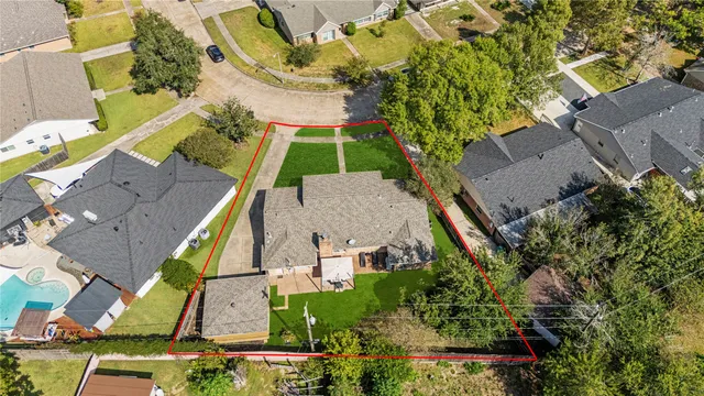 an aerial view of a house with a garden and trees