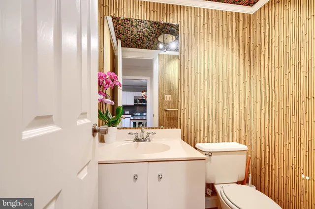 a bathroom with a sink and mirror with toilet