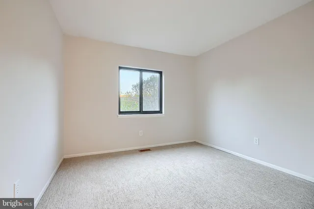 a view of an empty room and a window
