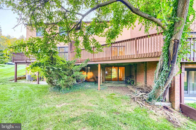 a view of swimming pool with lawn chairs under an umbrella
