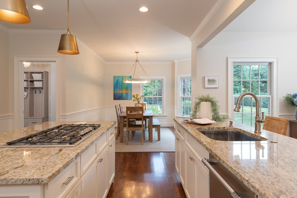 46 Concord Road Weston, MA 02493 - Photo 13 of 42 a kitchen with kitchen island a stove a sink a refrigerator dining table and chairs