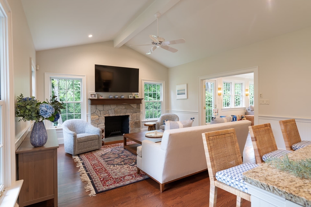 46 Concord Road Weston, MA 02493 - Photo 15 of 42 a living room with furniture a flat screen tv and a fireplace
