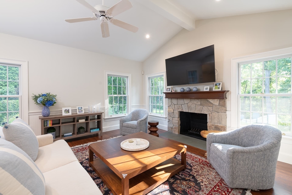 46 Concord Road Weston, MA 02493 - Photo 16 of 42 a living room with furniture a flat screen tv and a fireplace