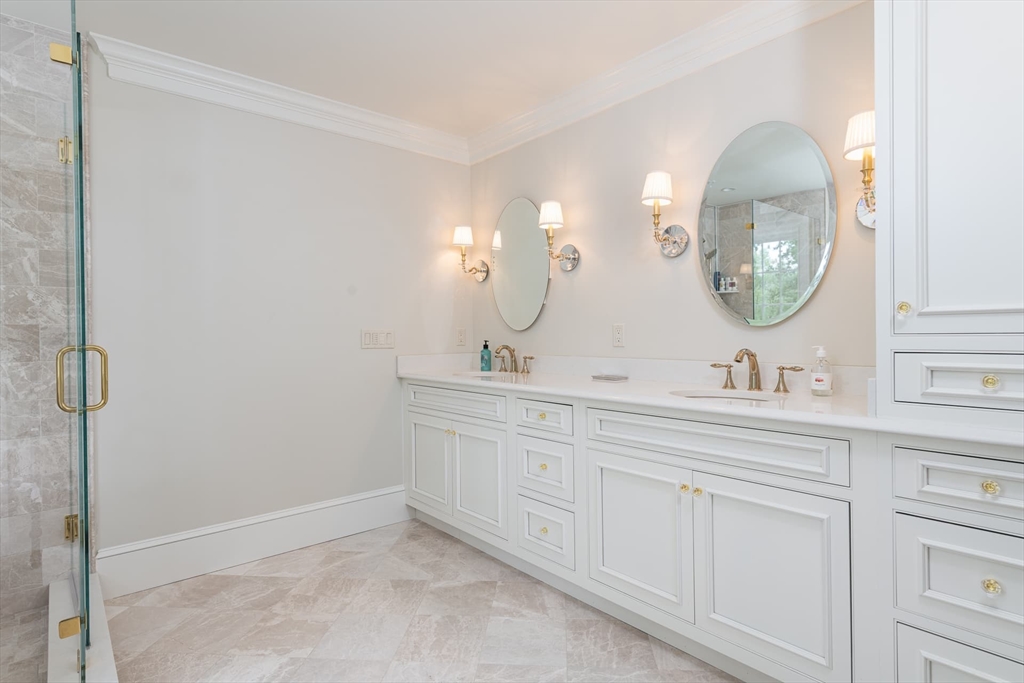 46 Concord Road Weston, MA 02493 - Photo 23 of 42 a bathroom with a double vanity sink and a mirror