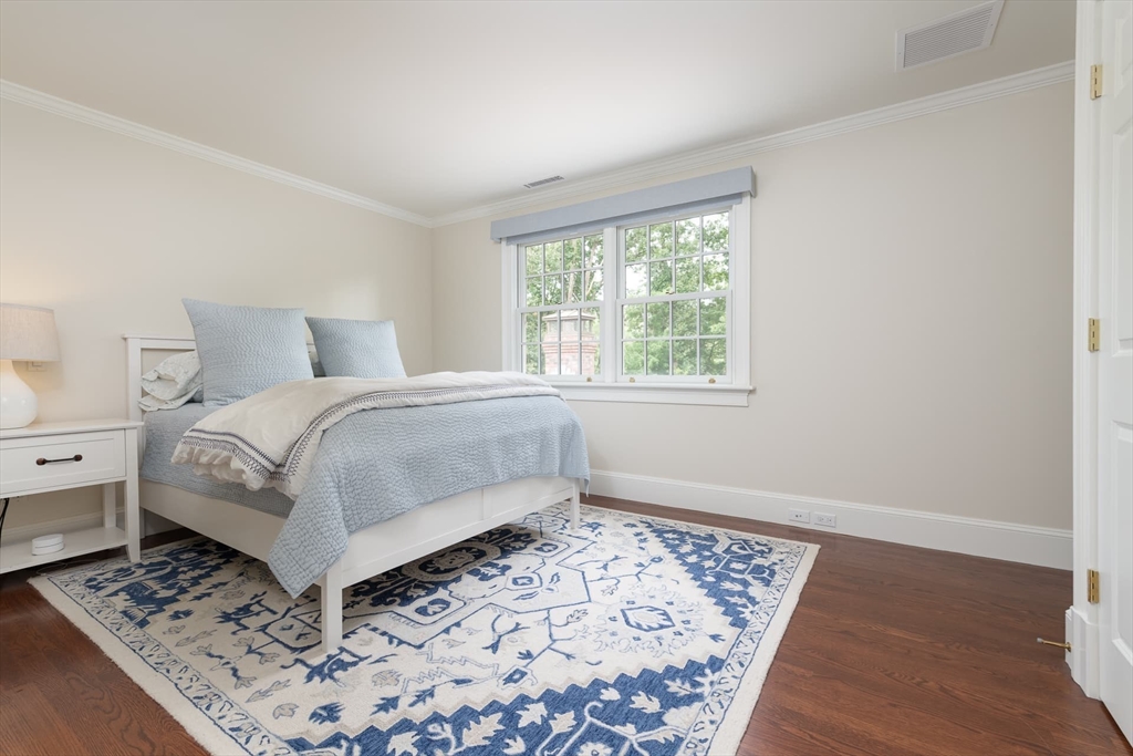 46 Concord Road Weston, MA 02493 - Photo 27 of 42 a bedroom with a bed and a window