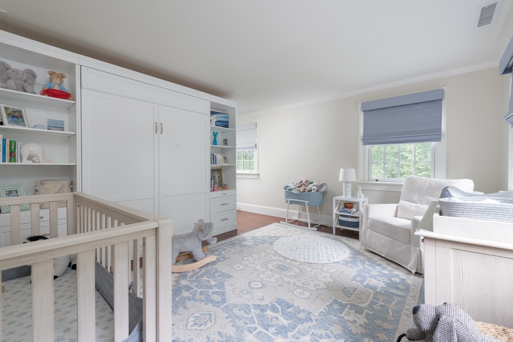 46 Concord Road Weston, MA 02493 - Photo 30 of 42 a living room with furniture and a book shelf
