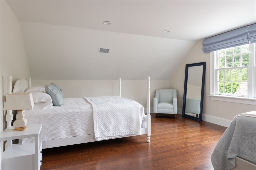 46 Concord Road Weston, MA 02493 - Photo 34 of 42 a bedroom with a bed and wooden floor