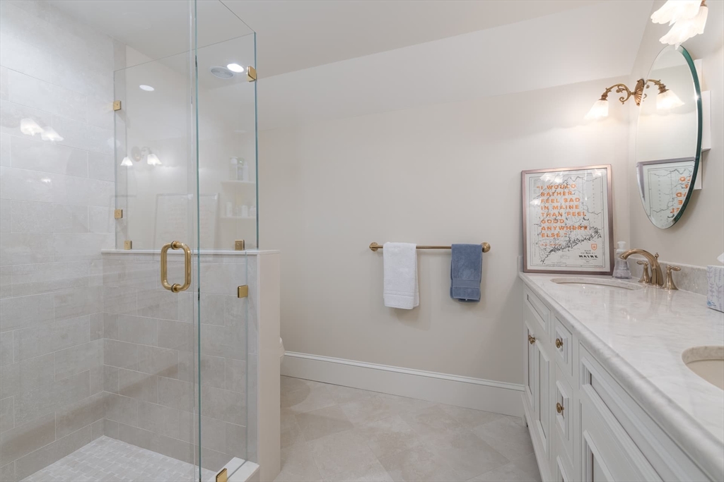 46 Concord Road Weston, MA 02493 - Photo 35 of 42 a bathroom with a granite countertop sink a shower and mirror