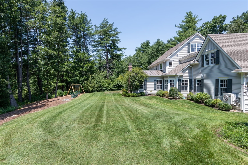 46 Concord Road Weston, MA 02493 - Photo 39 of 42 a aerial view of a house with swimming pool and green space