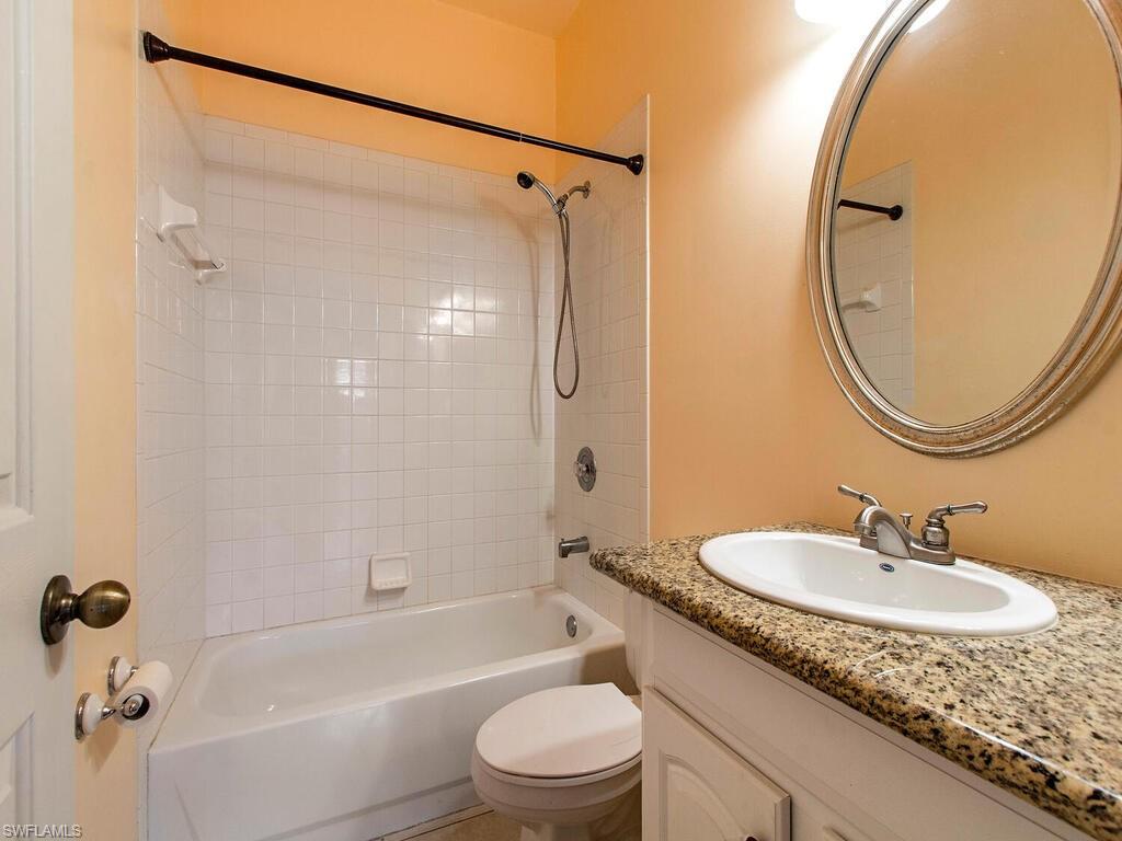 18254 Hepatica Road Fort Myers, FL 33967 - Photo 9 of 12 a bathroom with a granite countertop sink toilet and a mirror