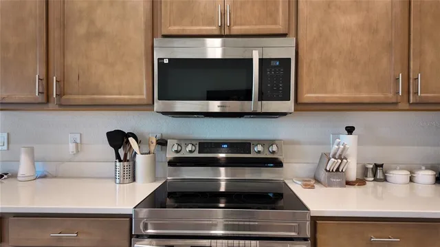 a kitchen with a stove and a microwave