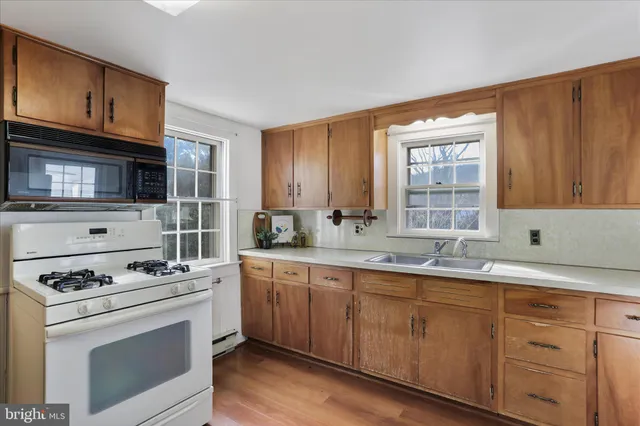 a kitchen with sink cabinets and appliances