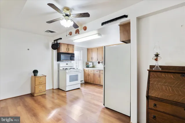 a view of a kitchen with a stove cabinets and a ceiling fan