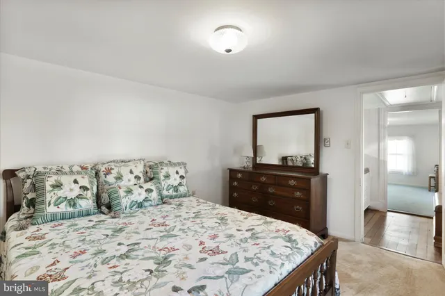 a bedroom with a bed and a dresser in it