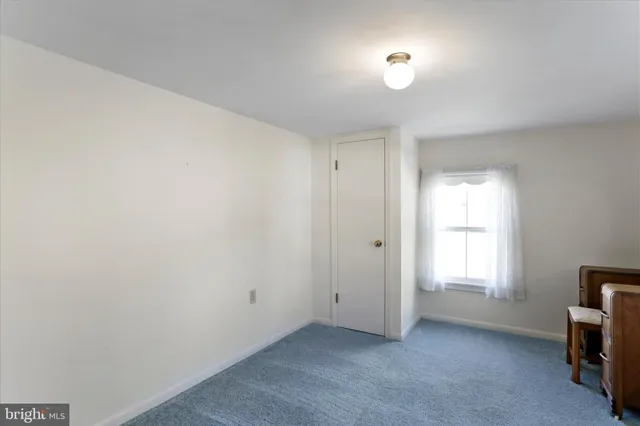 a view of a room with window and a flat screen tv