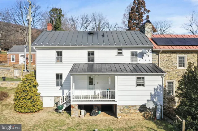 a view of a house with a yard and sitting area