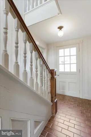 a view of staircase with white walls and a window